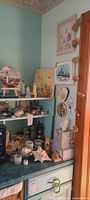 overall lot on painted shelf showing lamp, tissue box, shells, figurines