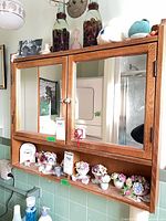 Front view of oak veneer medicine cabinet with mirrors and shelf
