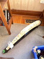 Full view of resin boat figurine on wood stand