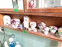 Shelf with mantel clock and multiple bone china floral posies