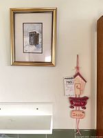 Large framed print and plaque on wall