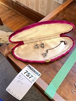 Set in case showing necklace, earrings, and chain