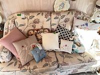 All eight decorative pillows displayed on sofa