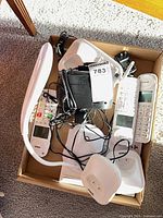 Box showing two VTech handsets, two cradles, black Westclox clock radio, LED lamp base, power adapters