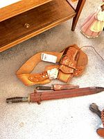 Belt holster and both knives with scabbards on floor