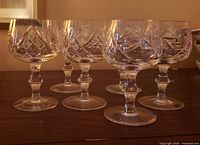 six cut crystal goblets on table