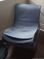 Front view of chrome frame rocking chair with blue sling seat