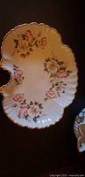 Top view of floral scalloped serving dish showing pattern and gold trim