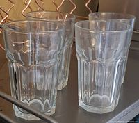 Four matching clear faceted drinking glasses