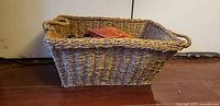 Side view of large burlap-style basket showing weave and handles
