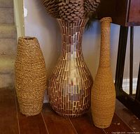 Front view of three vases showing materials and shapes