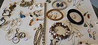 Full layout of costume jewelry lot including bracelets, earrings and rings