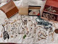 Full layout of jewelry with four boxes and assorted pieces