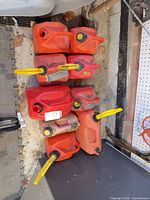 Top-view of stacked red jerry cans showing spouts and caps