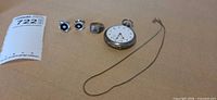 group shot of pocket watch, ring, cufflinks, chain