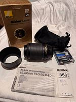 Lens with hood, filter package, pouch, manual and box