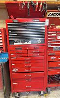 Full front view of stacked Husky and Gray red tool chest on casters