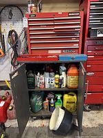 Mastercraft red tool chest on metal cabinet, cabinet doors open showing fluids