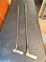 Two junior putters on table