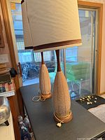 two matching ceramic table lamps with shades on table