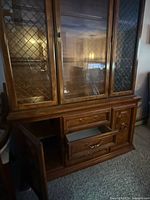 Front view of wooden china cabinet closed