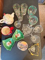 All items arranged on table: tumblers, goblets, champagne coupes, teapot, mug, candy dishes, coaster stack