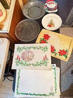 Group showing glass bowl, Santa plate, tree platter, ceramic tree plate, poinsettia tray, and placemats