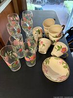 All items grouped: six tumblers, eight teacups, two bowls, Desert Rose pattern visible