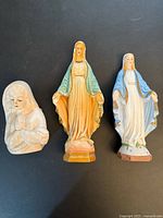 Front view of three Virgin Mary statues side by side