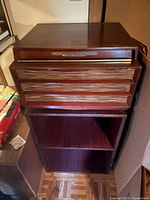 Full view of cabinet showing front speaker grille and lower shelf