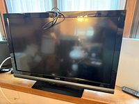Front view of 36-inch Vizio flat screen television with remote visible