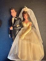 Plastic bride and groom cake topper with tulle veil