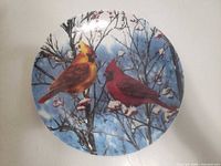 Front view of porcelain plate showing cardinal bird artwork