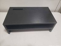 Top view of black rectangular low table with slot cut-out