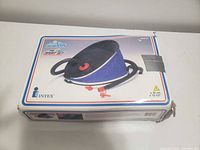 Boxed Intex blue/black bellows foot pump showing hose and adapters