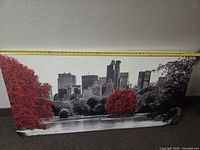 Front view of canvas print showing skyline and red trees