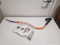 Full view of Bike Tow Leash arm, hardware bag, instructions