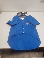 Front view blue Blue Jays pet jersey with buttons and logo