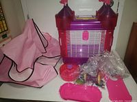 Full cage assembled with pink fabric bag and accessories