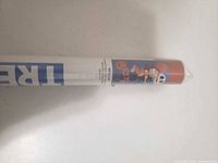 Close-up of poster end showing Jack and Sally graphic and factory seal