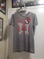Front view of gray Johnny Cash Ring of Fire T-shirt on hanger