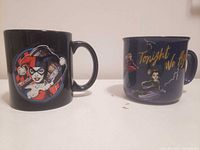 Front view of both mugs showing Harley Quinn image and Tonight We Fly design