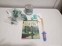 Overview of all items: book, candle, toy wand, plastic tokens and chips
