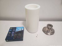 LED pillar candle, boxed Irish Coastlines coasters, brass taper candle holder front view