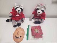 Entire lot: two plush raccoons in red hoodies, Ziploc bag with red Senators koozies, tan clay face mask