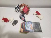 Overall lot with plush monkey, zebra, two white puppies, miniature shoe, paper spaceship, trading cards