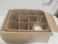 Assorted glasses packed in cardboard box with dividers