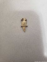 Front view of gold-tone parrot pendant