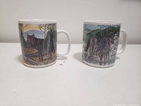 Front view of two mugs showing wolf artwork