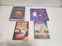 Four books laid out: Inkspell, The Wizard's Wish, High School Musical Junior Novel, Survivors The Empty City